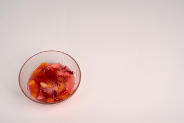 Jam for tea made from fresh nectarine and sugar in a bowl on a white background.