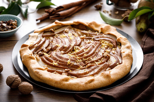 Pear galette with walnuts, cinnamon and lemon zest, autumn fruit pie with nuts