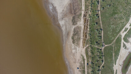 The bottom of a dried up salt lake. View from the air. Traces of cars and motorcycles in the sand.