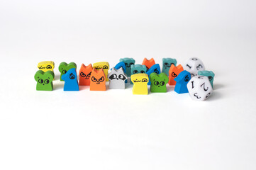 Small, wooden animal figurines for a board game on a white background.