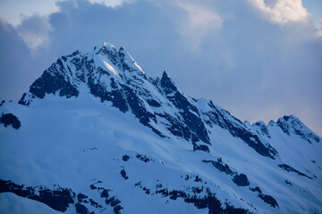 Snow on Tantalus Peak catches last sunlight before sunset, BC