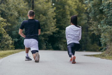 Obraz premium Male and female athletes preparing for a marathon, run, workout. Healthy lifestyle concept.