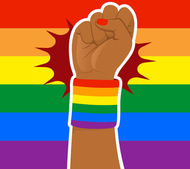 Rainbow colored LGBT flag background with black woman fist raised up wearing wristband