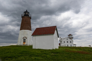 Fototapeta na wymiar Point Judith Lighthouse in Narragansett, Rhode Island, on a cloudy day in May