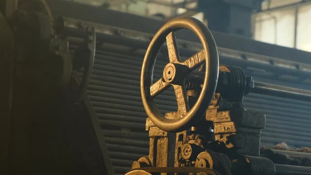 Close up old valve in abandoned manufacturing plant in smoke grainy footage. beautiful footage of yellow and blue lights in old disused abandoned factory or plant.