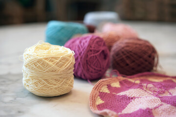 Crochet thread in group as many colors in studio of handicraft school as background. Needles craft...