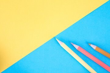 Colorful pencils on soft color background