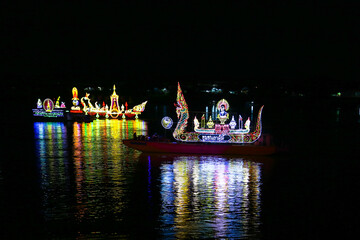 Traditional floating fire boat in Mekong river at night with light lamp as for Wan Ok Phansa is the...