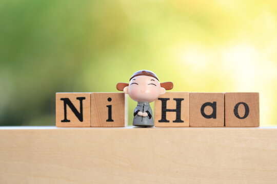 Chinese word on wooden block with green and light nature bokeh as background.