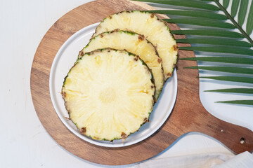 slices of pineapples on the plate, white background, isolated