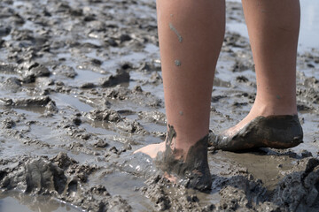 Girl bare foot on mudflat