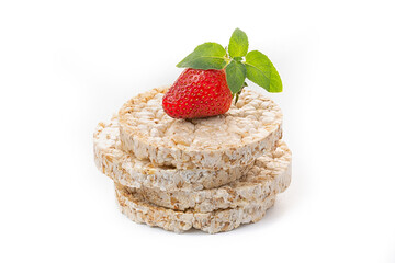 Airy oatmeal crispbreads in the form of breakfast slices decorated with mint leaf with strawberries. Dietary healthy food.
