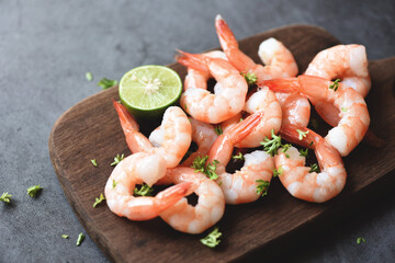Shrimp peeled on wooden cutting board background on the table food kitchen, Fresh shrimps prawns seafood lemon lime with herbs and spice