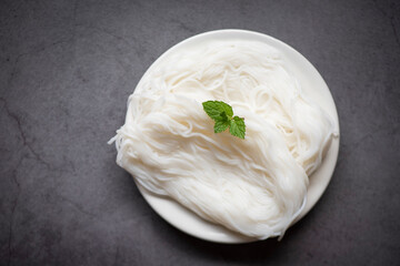 Thai rice noodles vermicelli on plate and black background, noodles for curry Thai food