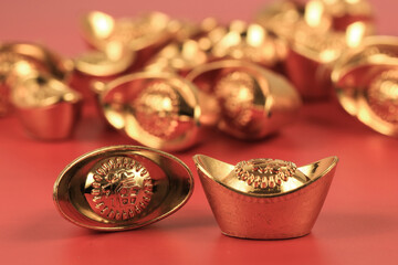 Golden chinese traditional money on red color background. Representing rich, wellness, properity, lucky, happiness for Chinese New Year celebration