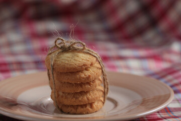 Round sweet cookies. Delicious dessert with high sugar and carbohydrate suitable for eating with milk and tea or coffee on color and white background with colorful placemat