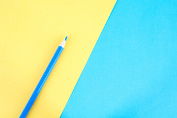 Paintbrush on yellow-blue background
