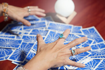 Tarot card reading on cloth for fate or fortune telling through design card. Gypsy paranormal in...