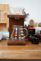 Accessories of Barista drips coffee with kettle and traditional drpper. Aroma blended black coffee handmade in coffee shop