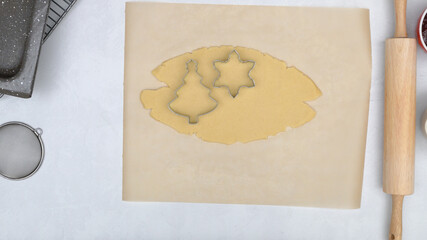 Cookie dough and cookie cutters close up on kitchen table. Shortbread cookies with raspberry jam close up baking process.