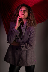 vertical portrait of a curly model wearing a jacket 