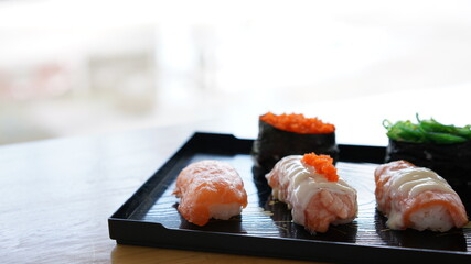 Sushi on plate. Variety Japanese rice in roll with many kinds of topping. Healthy menu.