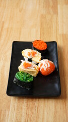 Sushi on plate. Variety Japanese rice in roll with many kinds of topping. Healthy menu.
