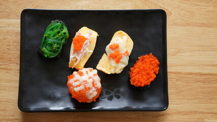 Sushi on plate. Variety Japanese rice in roll with many kinds of topping. Healthy menu.