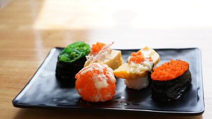 Sushi on plate. Variety Japanese rice in roll with many kinds of topping. Healthy menu.