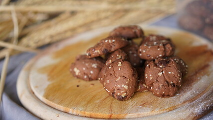 Oatmeal and banana chocolate cookies while preparation from dough to baking. Dessert recipe of pastry. Sweet homemade bake