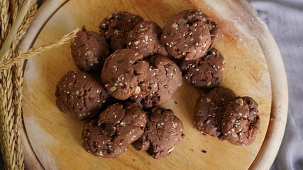 Oatmeal and banana chocolate cookies while preparation from dough to baking. Dessert recipe of pastry. Sweet homemade bake