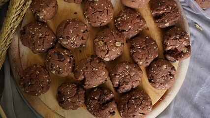 Oatmeal and banana chocolate cookies while preparation from dough to baking. Dessert recipe of pastry. Sweet homemade bake