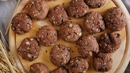 Oatmeal and banana chocolate cookies while preparation from dough to baking. Dessert recipe of pastry. Sweet homemade bake