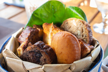 Fresh bread in basket. Homemade bakery close up. Delicious pastry concept. Basket of tasty banana bread and bun. Breakfast concept. Piece of bread. Breakfast in hotel.