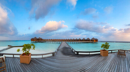 Maldives paradise scenic landscape. Seascape with water bungalows, turquoise sea and lagoon waters, tropical nature. Exotic tropical island beach background. Romantic holiday & honeymoon destination.