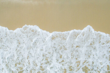 Soft wave of blue ocean on sandy beach. aerial view