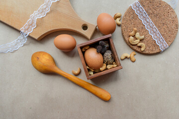 Fototapeta na wymiar Brown eggs on wood and craft paper background