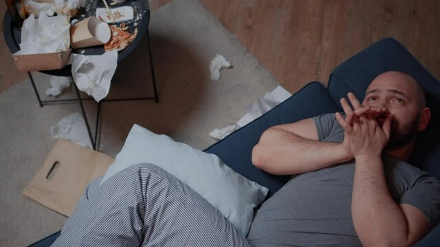 Fatigued, sad, depressed, traumatized adult man finding news that makes to fall into desperation suicidal state, crying and feeling unhappy, vulnerable, desperate suffering from anxiety and loneliness