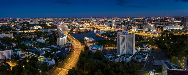 Fototapeta premium buildings and streets illuminated at night in Minsk downtown. city skyline panorama at night.