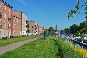 New apartment blocks beside the river with the stump tower in the distance.