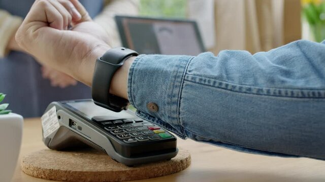 Close-up hand asia woman people work in small sme coffee caf&eacute; shop store owner use cashless wifi paywave nfc scan app smart pos reader sale in take out food drink order in urban city life contactless.