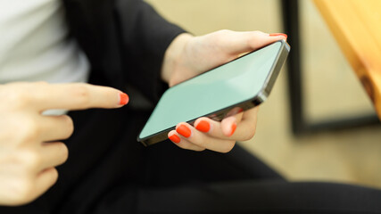 Female office worker hands using smartphone with mock-up screen