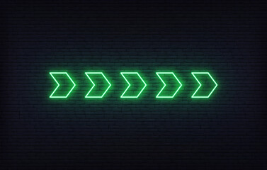 Neon arrow sign. Set of green glowing neon arrow pointer on brick wall background