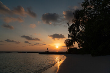 Wide panoramic landscape of stunning sunset over Indian Ocean on Maldives island. Exotic tropical island beach background. 