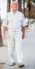 Portrait of mature man walking in the park at weekend