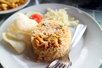 Fried rice on a white plate with crackers
