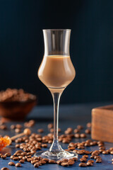 Irish cream or Coffee Liqueur and coffee beans on blue background