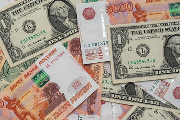Fototapeta na wymiar One dollar and five thousand rubles cash banknotes. Business concept