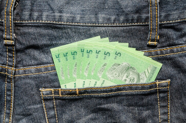 Five Ringgit Malaysia in the back pocket of blue jeans