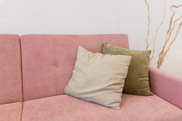 Living room furniture. Comfortable couch with pillows. modern room with pink sofa and row of pillows. sipmle interior design. copy space